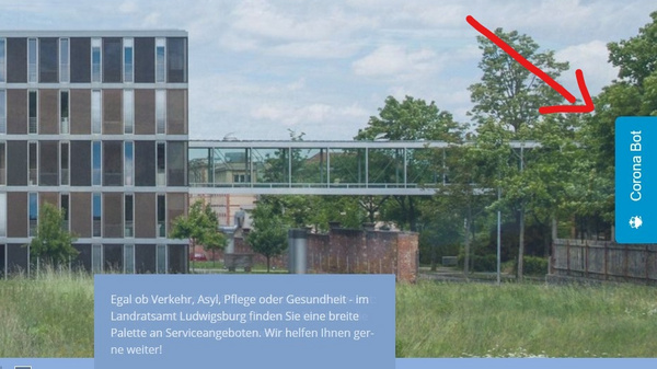 The image features a modern building with large windows and a landscaped area in front. A prominent arrow points towards a button labeled "Contact Us," indicating a way for users to reach out for more information or assistance. The overall design suggests a focus on accessibility and communication.