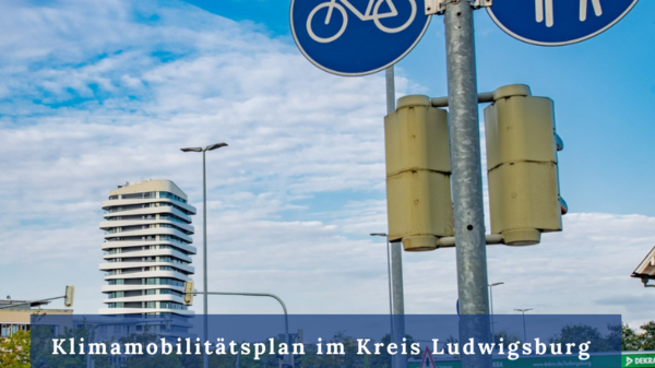 A cityscape featuring traffic signs, including bicycle and pedestrian symbols. Prominent text promotes a climate mobility plan event in Ludwigsburg, scheduled for December 12th. The image emphasizes urban infrastructure and community sustainability initiatives.