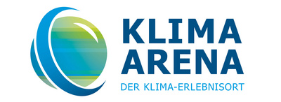 Das Logo der Klima Arena zeigt den Schriftzug „KLIMA ARENA“ in blauen Buchstaben. Darunter steht „DER KLIMA-ERLEBNISORT“. Das Design beinhaltet ein stilisiertes, farbiges Element, das den Fokus auf Klima- und Umweltthemen legt.