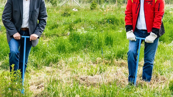 Drei Männer stehen in einem grünen Feld, bereit, Bäume zu pflanzen. Sie halten Schaufeln und tragen rote Jacken sowie Hosen. Im Hintergrund sind Bäume und eine natürliche Landschaft zu sehen. Die Szene vermittelt eine positive Botschaft des Umweltschutzes und der Aufforstung.