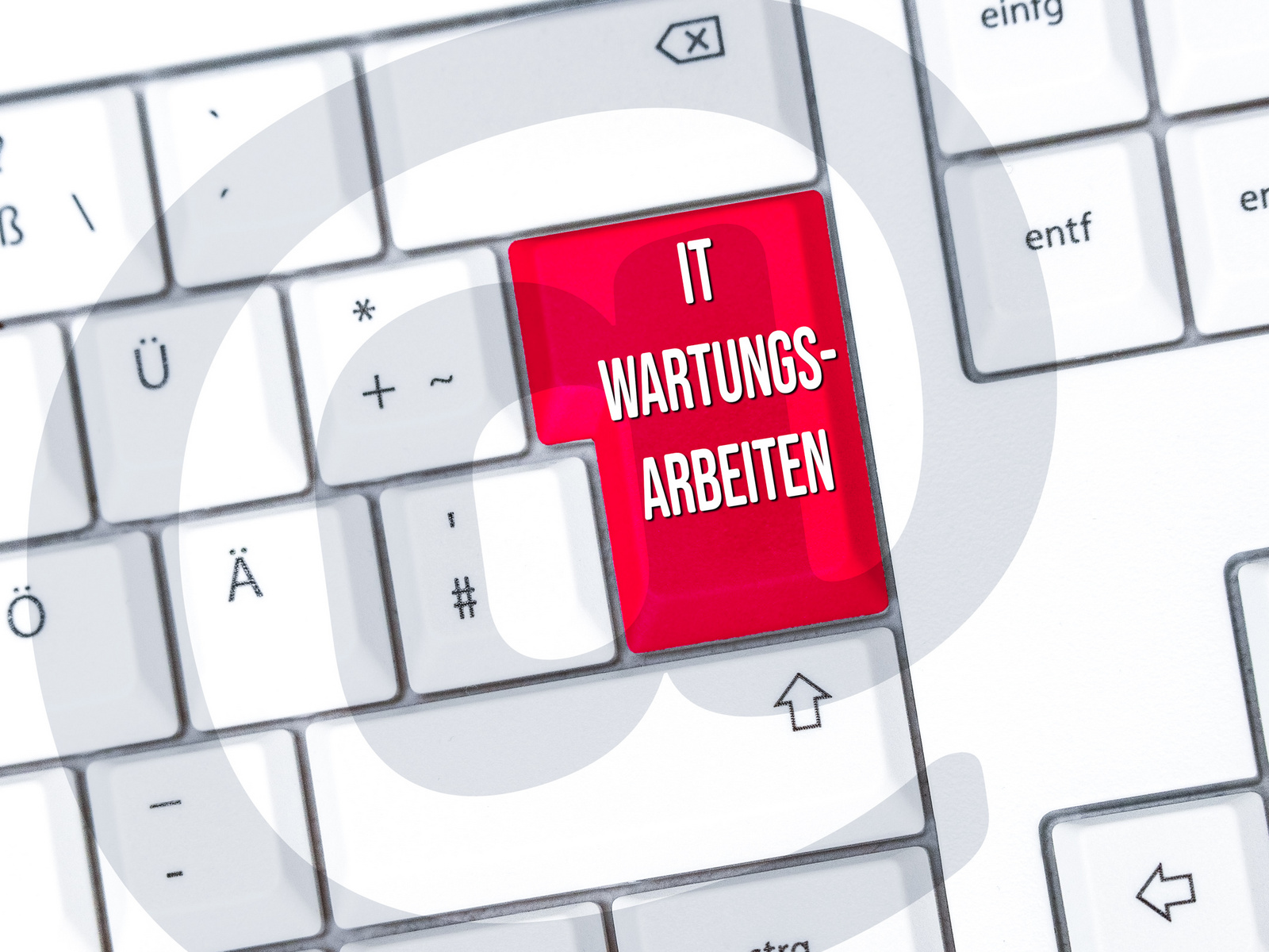 Ein Computer-Tastatur mit einer hervorgehobenen roten Taste, auf der "IT WARTUNGS-ARBEITEN" steht. Der Hintergrund enthält ein grafisches Element, das eine Art Kreis oder Welle darstellt. (Text KI generiert)
